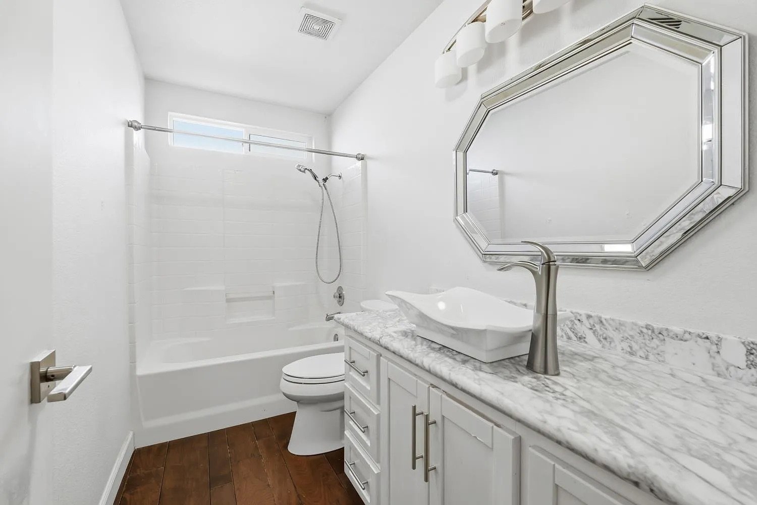 Hall Bathroom with Marble Vanity and Tub/Shower