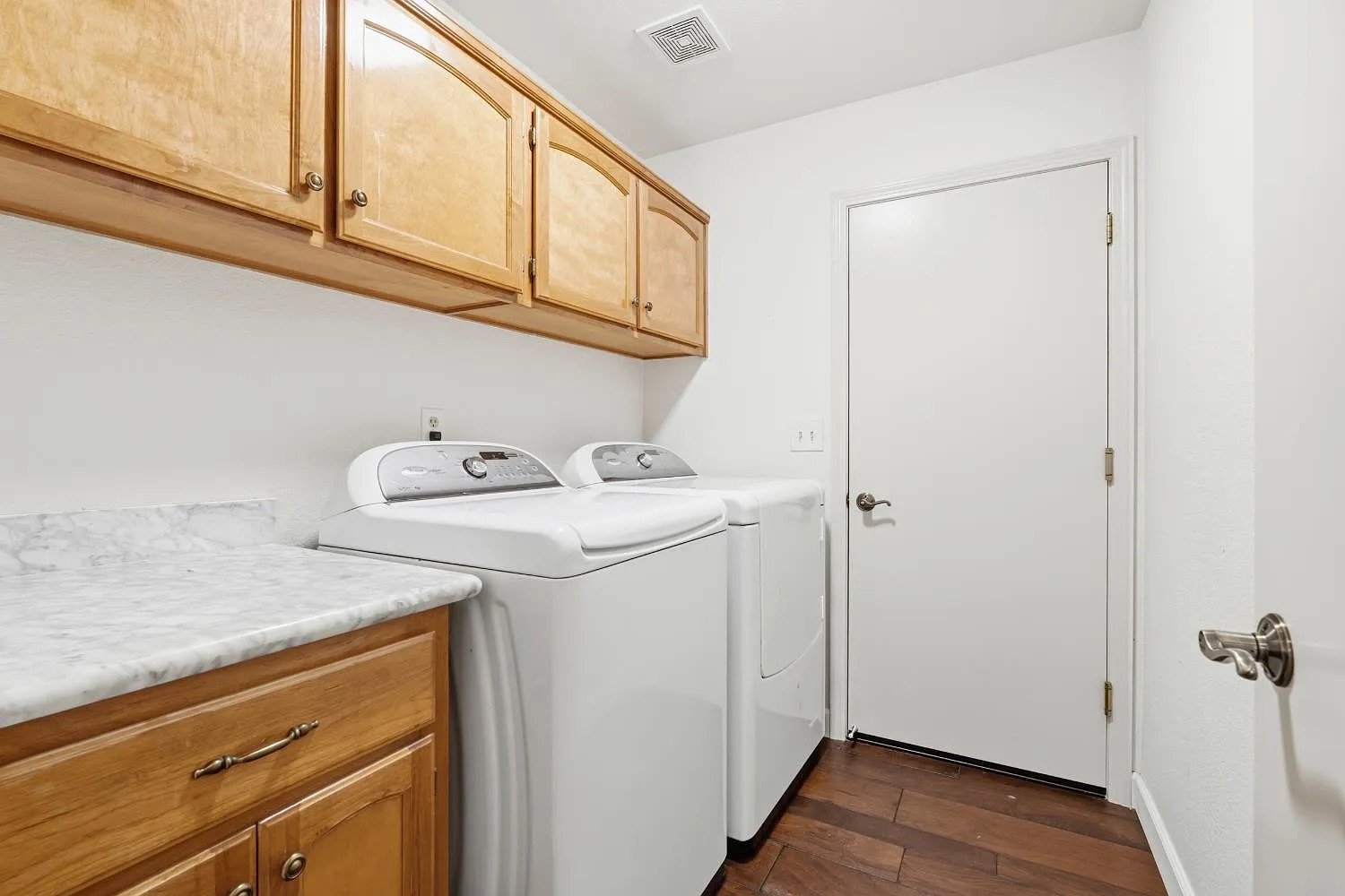 Laundry Room with Upper Cabinets and Garage Access