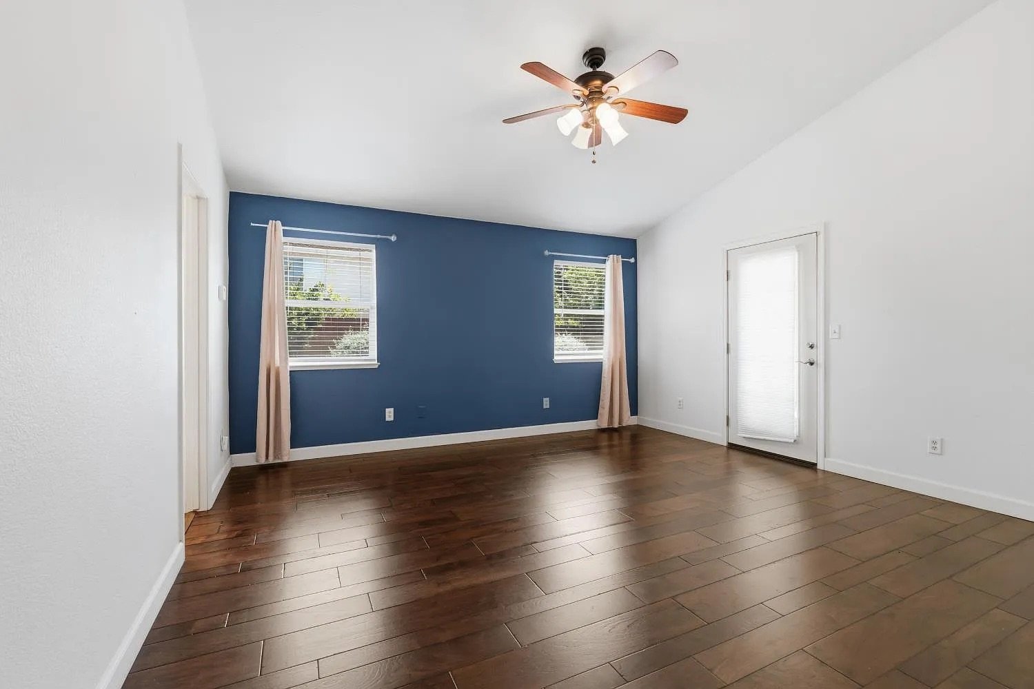 Primary Bedroom with Blue Accent Wall and French Doors