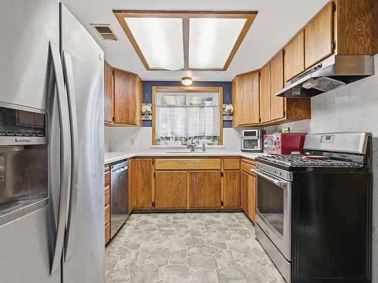 Kitchen with oak cabinets and gas range