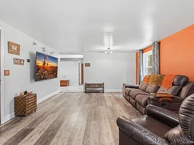 Family Room — orange accent wall, leather sectional