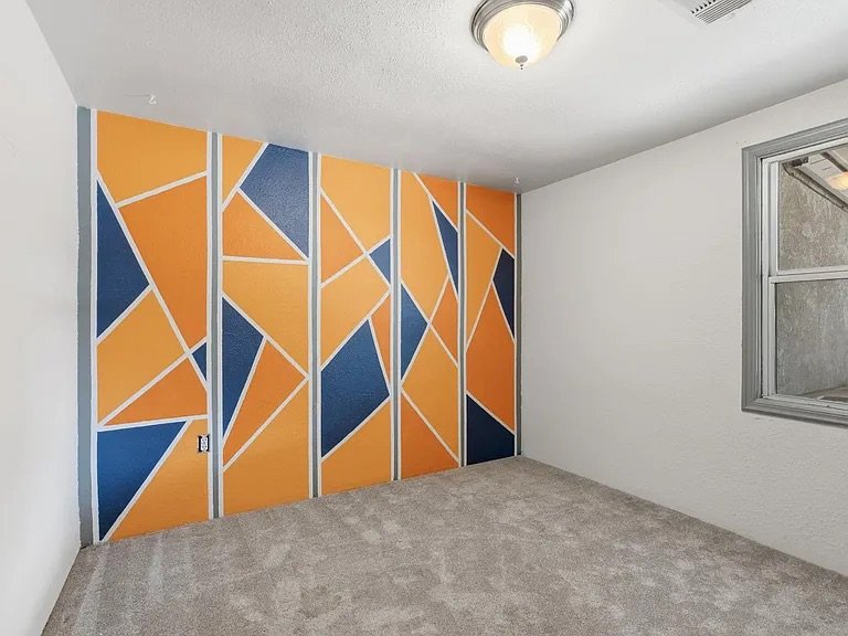 Bedroom — geometric orange and blue accent wall