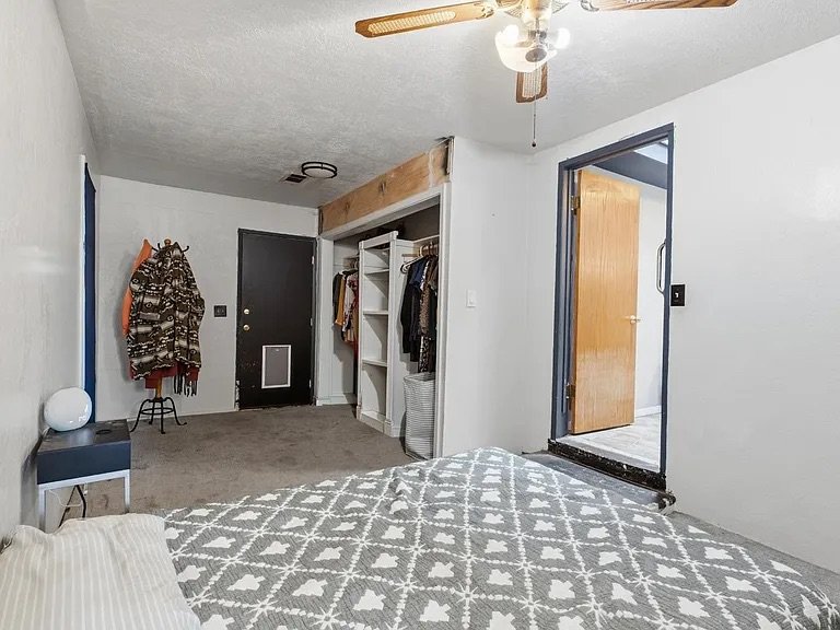 Primary Bedroom — carpet, closet, private exterior door